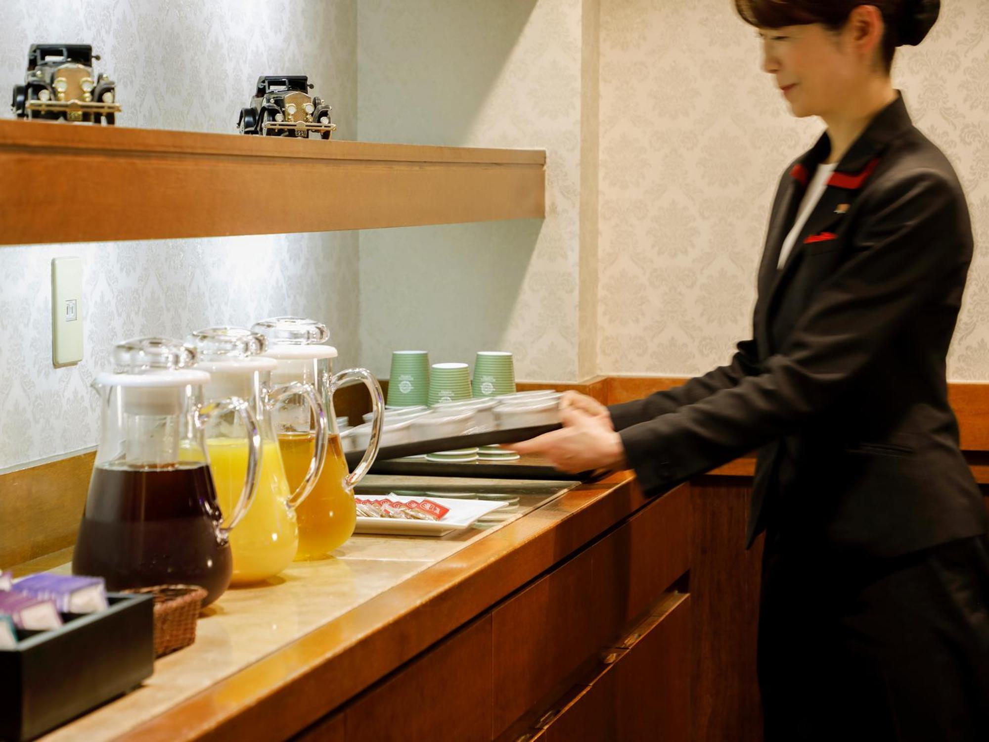 Premier Hotel -Tsubaki- Sapporo Exterior photo A flight attendant working on board a plane